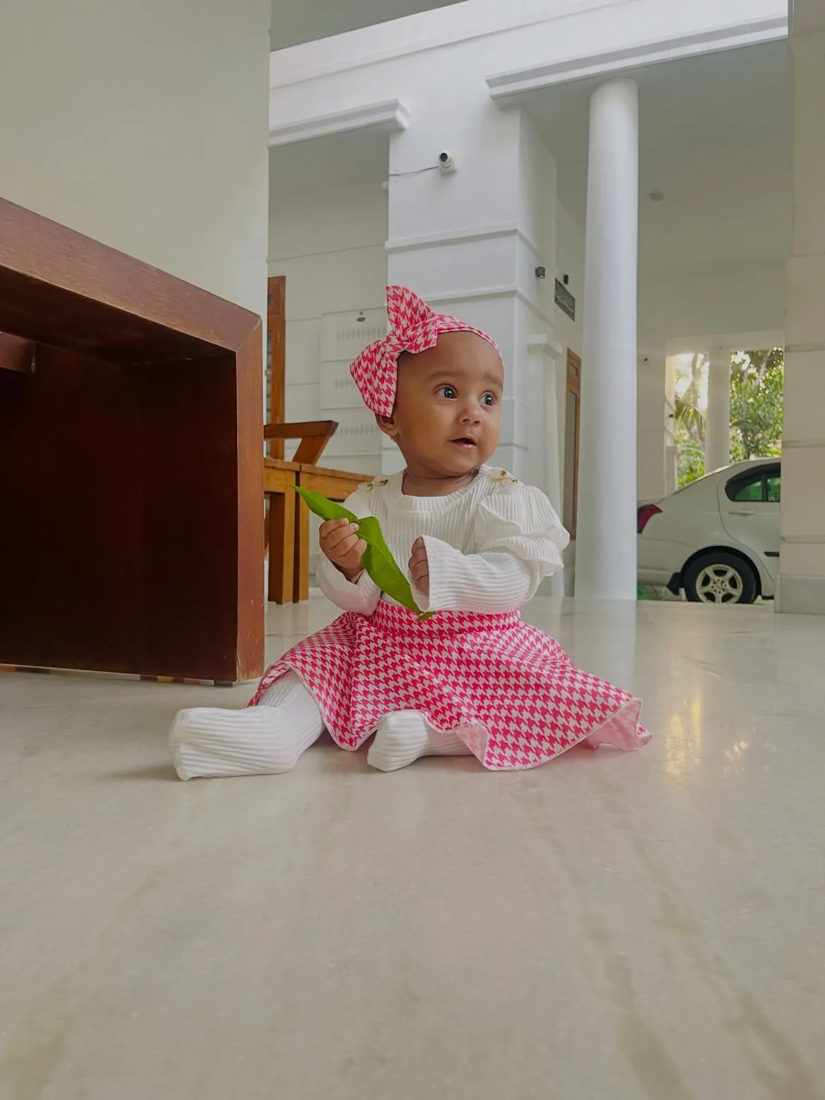 Baby girl smiling in pink floral dress